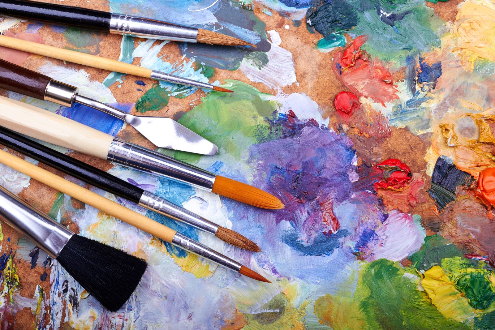 photo of art brushes and paint strokes
