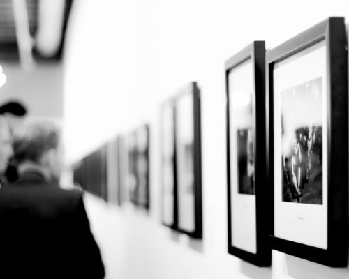 black and white of pictures hung on museum wall