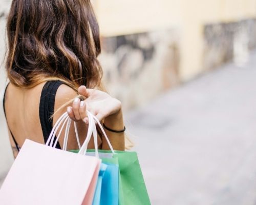 woman walking holding shopping bags