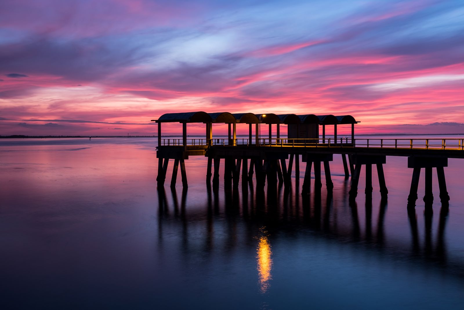 fishing pier in jekyll island at sunset